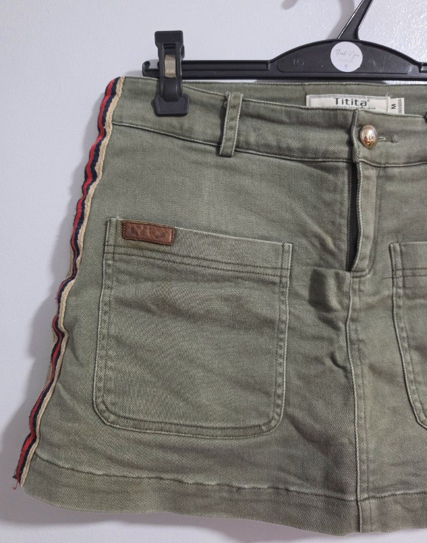 Olive Green Skort with Side Stripes Size M (Category: Skirts) located in Paranaque City. Submitted by franinnashop (Listing ID 1470839719, Image 3). Description: Declutter •Olive green skort from Titita in size M (160/80A). •Built-in inner shorts for extra comfort and coverage. •Two large front pockets with a small brown leather patch, plus two faux welt pockets on the back. •Red, navy, and beige side stripes add casual sport vibe. •Waist measure