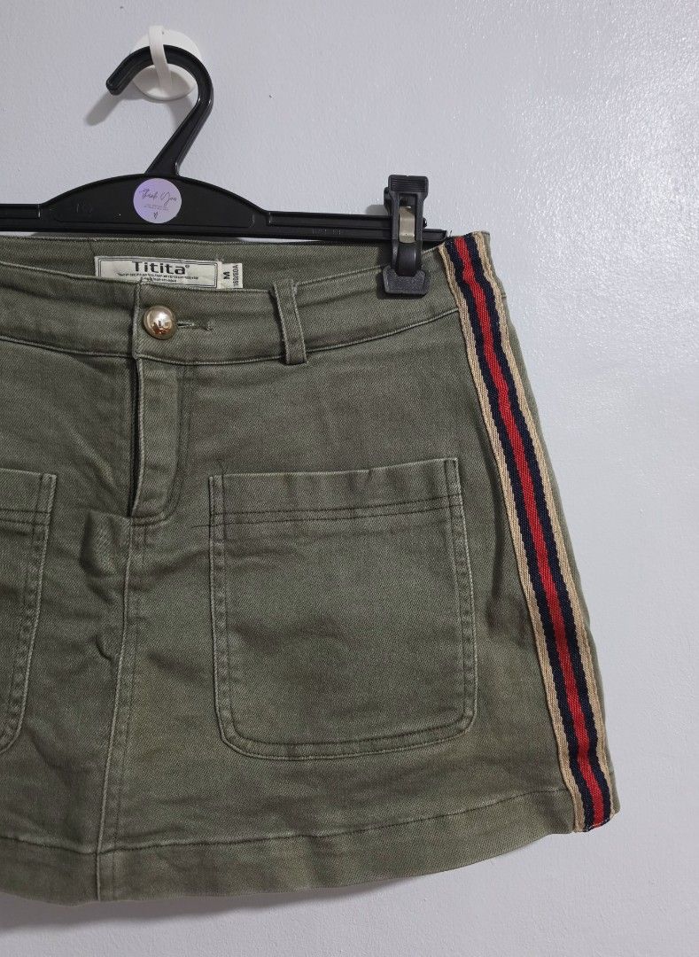 Olive Green Skort with Side Stripes Size M (Category: Skirts) located in Paranaque City. Submitted by franinnashop (Listing ID 1470839719, Image 2). Description: Declutter •Olive green skort from Titita in size M (160/80A). •Built-in inner shorts for extra comfort and coverage. •Two large front pockets with a small brown leather patch, plus two faux welt pockets on the back. •Red, navy, and beige side stripes add casual sport vibe. •Waist measure