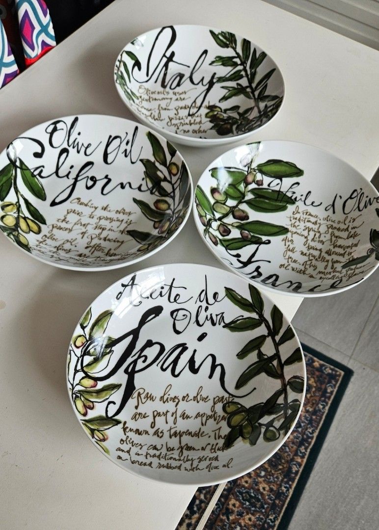 Olive themed ceramic bowls set with typography and art (Category: Dinnerware & Cutlery) located in Manila. Submitted by cosmicshark-cd31f1 (Listing ID 1470822391, Image 2). Description: - Set includes 4 individual bowls and 1 large matching serving bowl - Features charming olive branch illustrations and typography of famous olive regions (Spain, Italy, California, France) - Made of durable white ceramic with classic black typography and green acc