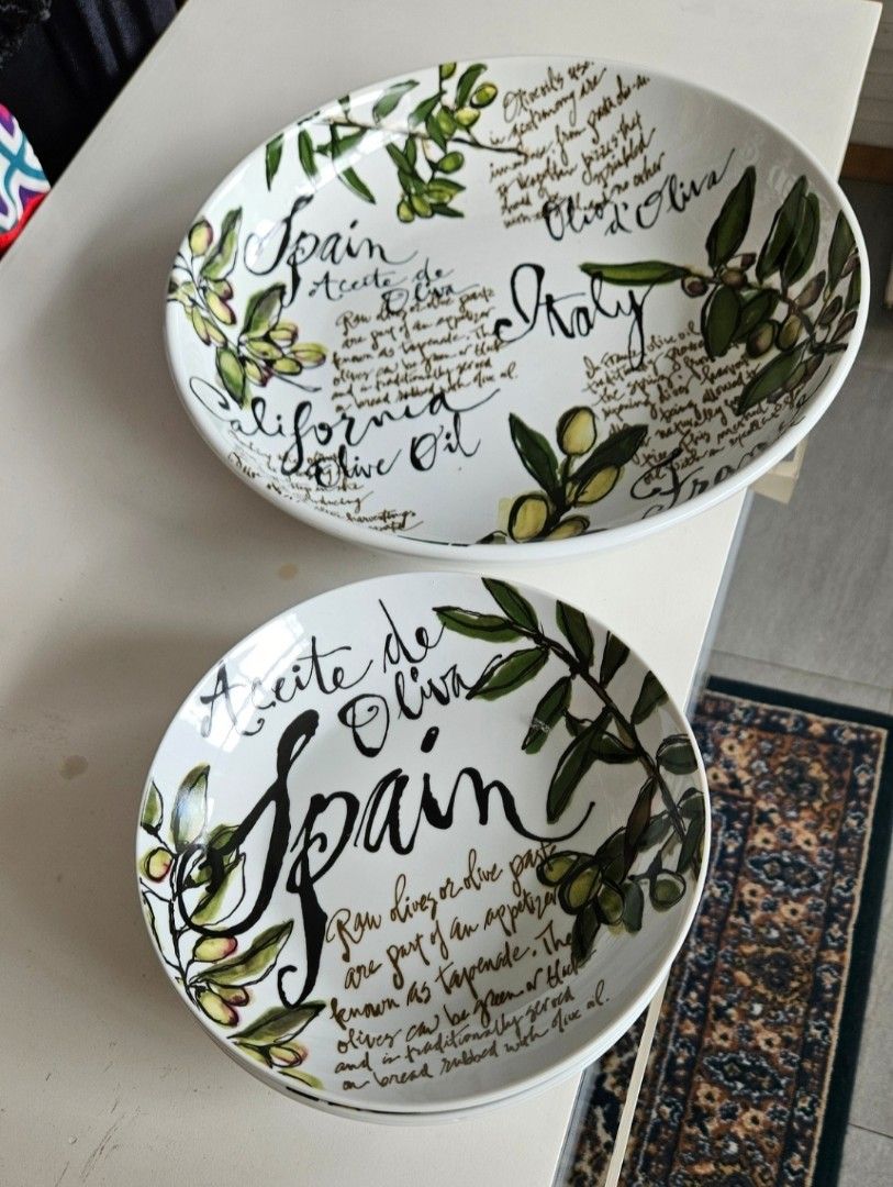 Olive themed ceramic bowls set with typography and art (Category: Dinnerware & Cutlery) located in Manila. Submitted by cosmicshark-cd31f1 (Listing ID 1470822391, Image 1). Description: - Set includes 4 individual bowls and 1 large matching serving bowl - Features charming olive branch illustrations and typography of famous olive regions (Spain, Italy, California, France) - Made of durable white ceramic with classic black typography and green acc
