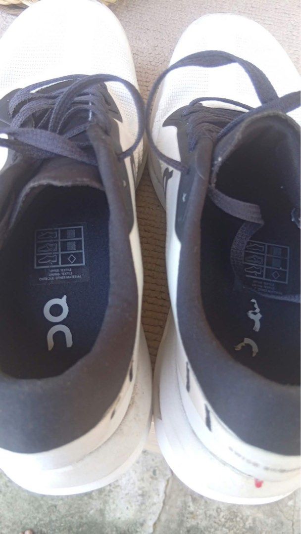 On Cloud Running Shoes White Black (Category: Sneakers) located in Muntinlupa City. Submitted by ashley.18 (Listing ID 1470767852, Image 2). Description: - Brand: On Running Shoes - Color: Classic White and Black - Style: Iconic Cloud design with convenient speed-lacing system - Material: Breathable mesh upper for maximum airflow - Condition: Good pre-owned condition with plenty of tread left on rubber outsoles - Flaws: Visible scuffs/dirt marks 