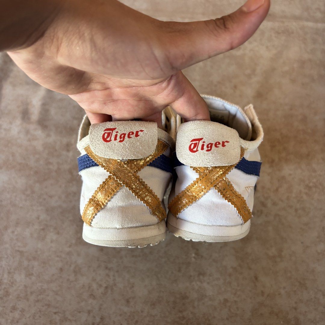 Onitsuka Tiger Mexico 66 White Blue Red (Category: Casual Shoes) located in Dipolog. Submitted by dionato (Listing ID 1470821468, Image 3). Description: - Brand: Onitsuka Tiger - Model: Mexico 66 Canvas Sneakers - Colorway: White base with blue/gold stripes and red accents - Features: Gold heel tab with red embroidered Tiger logo, metal eyelets, and classic low-top design - Condition: Pre-owned with slight dirt on the textured rubber outer soles 