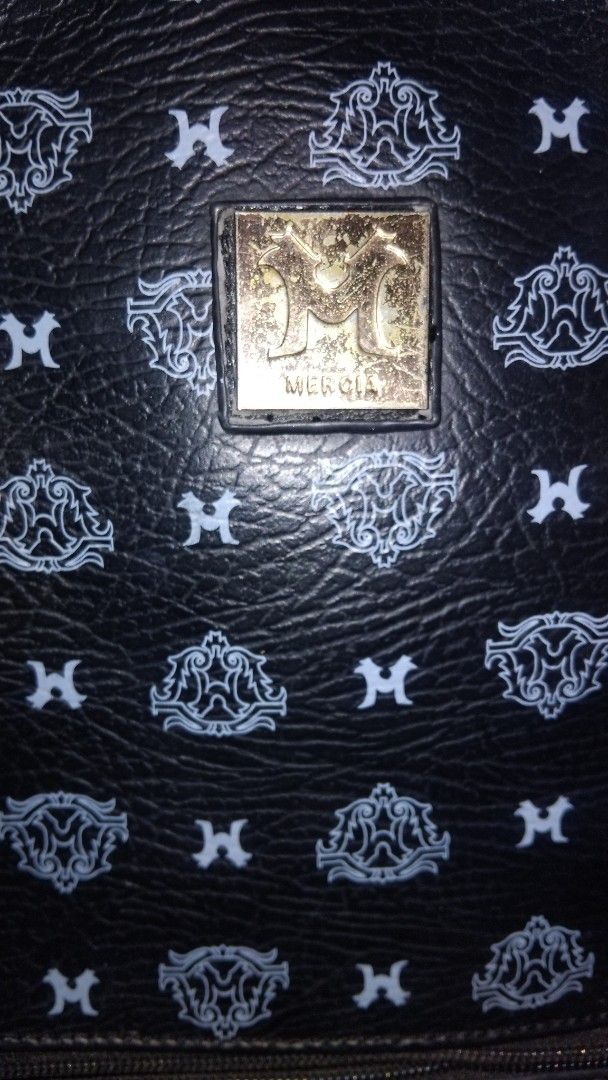 ORIGINAL MERCIA MONOGRAM BACKPACK (Category: Backpacks) located in Iloilo. Submitted by ayinscloset (Listing ID 1470789200, Image 2). Description: 🖤 ORIGINAL MERCIA MONOGRAM BACKPACK FOR SALE Price: ₱650 (Negotiable) Condition: Preloved - 100% Original Mercia - Black monogram design with gold-tone hardware - All zippers are smooth and fully functional - Spacious main compartment with multiple pockets - Adjustable shoulder straps - Exterior print