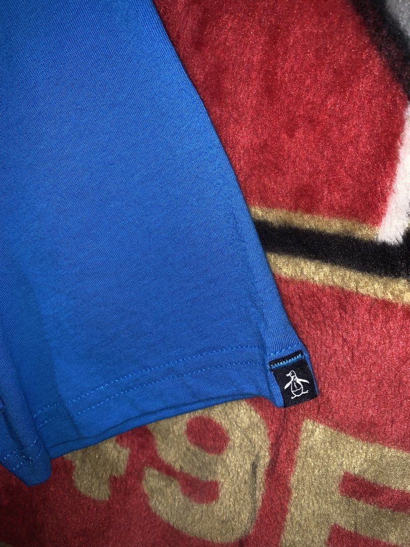 Original Penguin Graphic Tee Blue Size M (Category: Tshirts & Polo Shirts ) located in Tayug. Submitted by cvcthrift (Listing ID 1470895171, Image 3). Description: 21/29 NO ISSUE BNEW CONDI CR-9.5/10 - Brand: Original Penguin by Munsingwear - Condition: Brand new with original retail tags attached - Color: Bright blue - Material: 100% Cotton (Made in El Salvador) - Design: Large white chest graphic with logo and 'EST 1955' text, plus a small bran