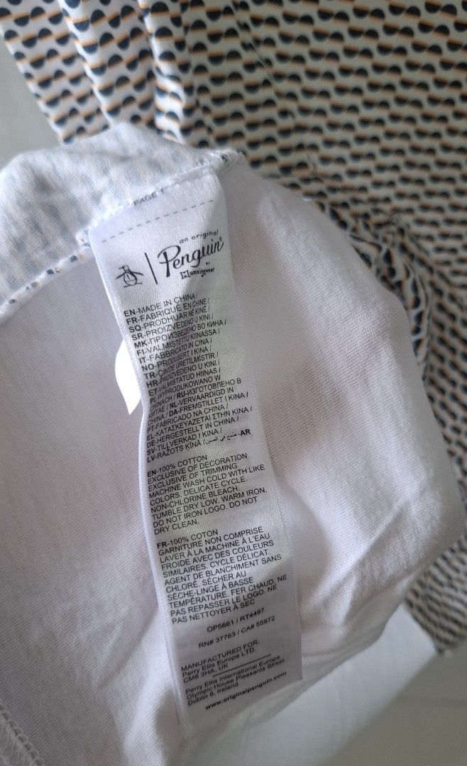 Original Penguin Patterned Polo Shirt (Category: Tshirts & Polo Shirts ) located in Taguig. Submitted by atticusmerch (Listing ID 1470779755, Image 3). Description: - Brand: Original Penguin - Color: White with geometric half-circle pattern on front (solid white back and sleeves) - Material: 100% Cotton, machine washable - Fit: Standard fit - Features: Short sleeves, button placket, collar with contrast piping - Condition: Brand new / Excellent q