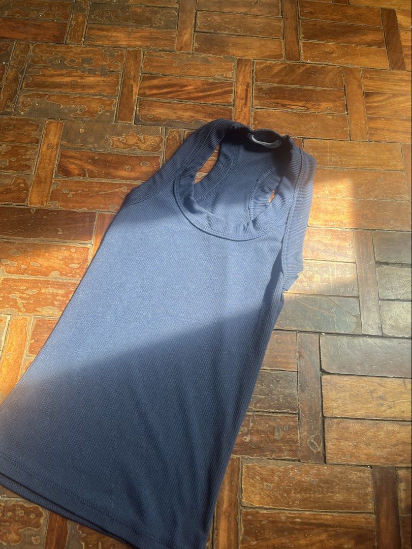OURA Blue Ribbed Racerback Tank Top (Category: Sleeveless) located in Mandaluyong City. Submitted by copthatgirl (Listing ID 1470888508, Image 1). Description: - Color: Navy blue - Material: Stretchy cotton, clean and stain-free - Design: Racerback with thick ribbed collar - Fit: Slim fit, standard length (hits at hips) - Condition: Great pre-loved condition, no loose threads - Versatility: Perfect basic for layering or solo wear.