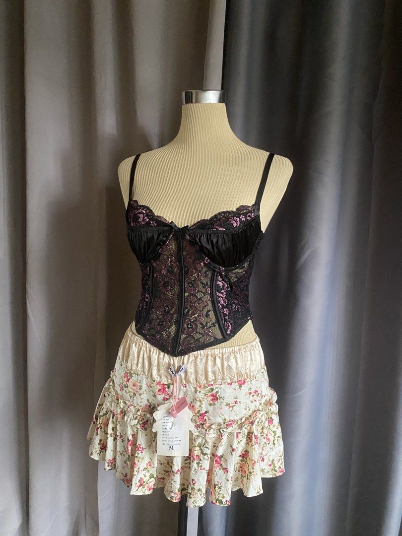 Outcast Black & Pink Lace Panel Corset Top (Category: Sleeveless) located in Cagayan de Oro. Submitted by curated_closetph (Listing ID 1470747137, Image 2). Description: — Size: XS - S — Color: Black / Pink — Sheer floral lace panels with a satin-finish bust and center bow — Sweetheart neckline with underwire cups and adjustable straps — Lace-up string tie back closure — Sharp pointed asymmetrical hem — Fully structured bodice lines — Can negotia