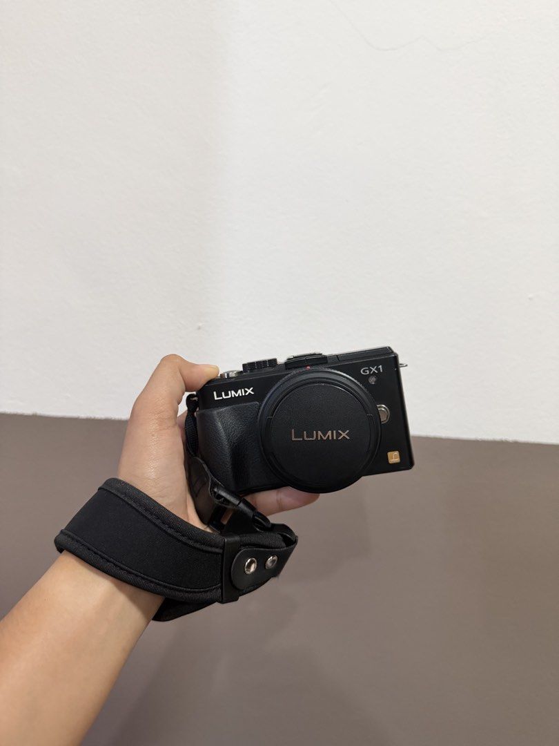 Panasonic Lumix DMC-GX1 Mirrorless Camera with Strap (Category: Cameras) located in Las Pinas. Submitted by myqanorella (Listing ID 1470930543, Image 1). Description: - Model: Panasonic Lumix DMC-GX1 Mirrorless Camera (Black) - LANGUAGE: Japanese (NO BUILT IN LANGUAGE CHANGER) - Format: Compact Micro Four Thirds body with low-profile lens - Included: LUMIX G branded neck strap and lens cap - Condition: Fully functional dials, buttons, and rear sc