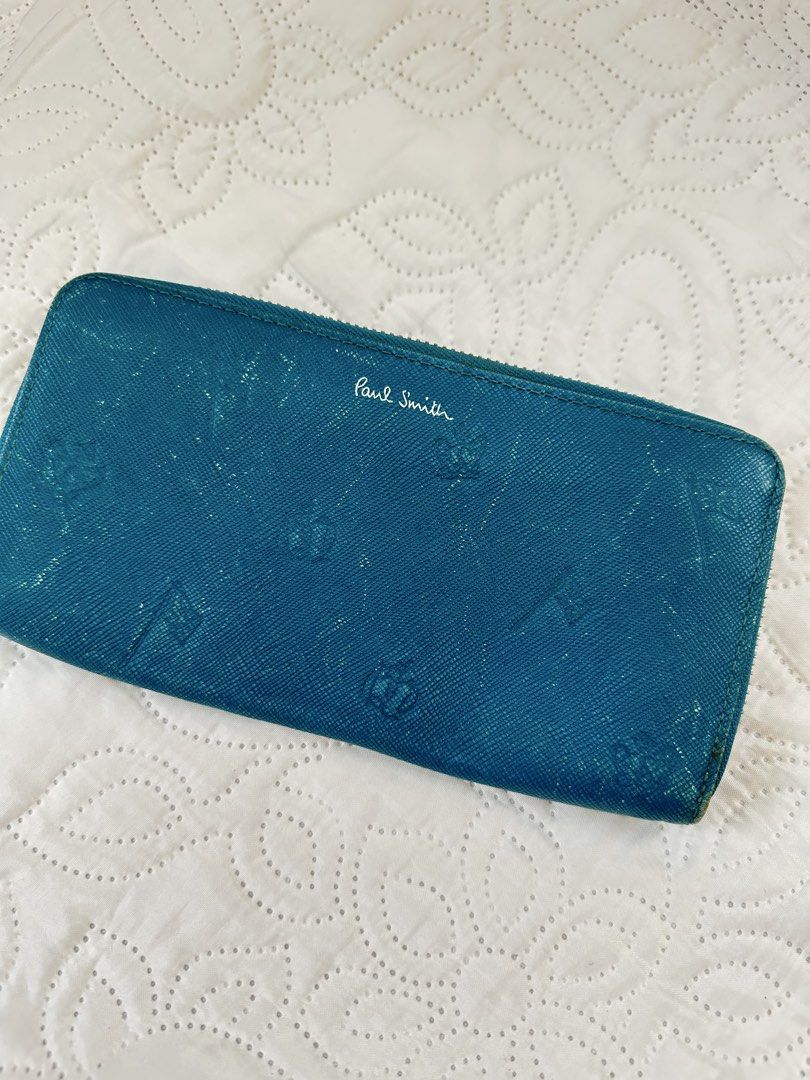Paul Smith Teal Blue Zip Around Long Wallet (Category: Wallets & Card holders) located in Batangas. Submitted by enyahsnivl56498 (Listing ID 1470768867, Image 2). Description: - Brand: Paul Smith - Color: Teal blue - Material: Textured leather with subtle embossed patterns - Hardware: Silver-tone hardware and zipper pull - Closure: Full zip-around closure for security - Storage: Exterior back slip pocket for quick-access cards - Condition: Clean 