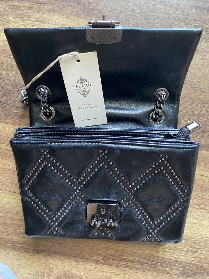 Pazzion Black Studded Shoulder Bag (Category: Luxury Bags & Wallets) located in Paranaque City. Submitted by boogru (Listing ID 1470762428, Image 2). Description: - Stylish black leather-look finish with edgy metal studs in diamond patterns - Bold chunky dark metal chain strap for a trendy look - Secure flap closure with twist-lock hardware - Well-organized interior featuring multiple compartments and a secure zip pocket - Perfect statement bag f