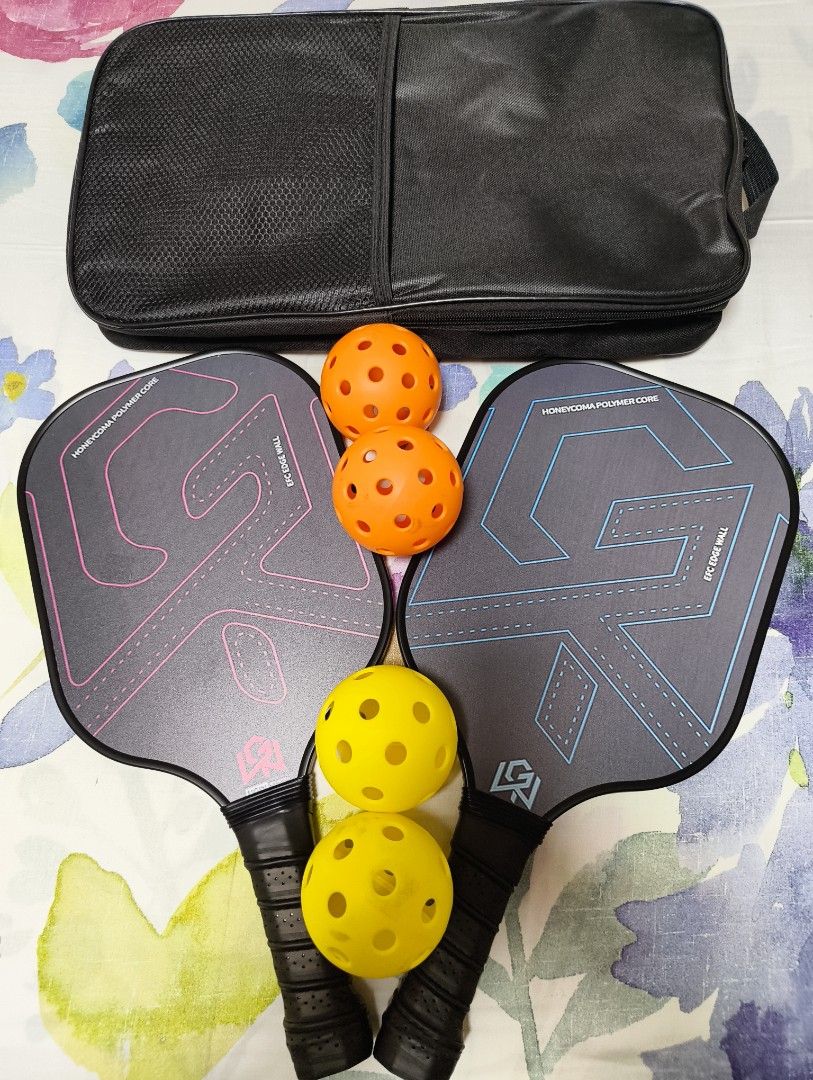 Pickleball Paddle Set with 4 Balls and Carry Bag (Category: Racket and Ball Sports) located in Pasay City. Submitted by purecrystal.7c6df8 (Listing ID 1470819664, Image 1). Description: - Complete pickleball set: Includes 2 paddles, 4 balls, and a handy carrying bag - Stylish & practical: One paddle with pink accents, the other with blue - High-performance design: Honeycomb polymer core construction for durability and control - Comfortable play: 