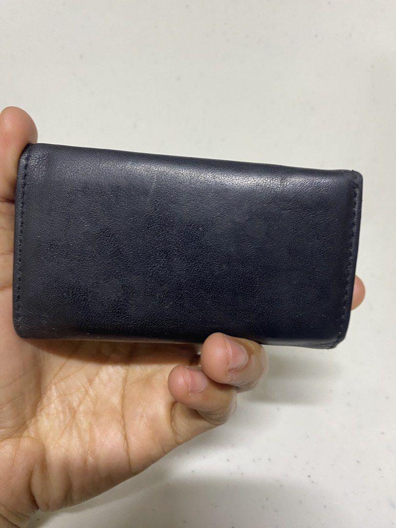 Pierre Cardin Black Leather Key Case Holder (Category: Wallets & Card holders) located in Pasacao. Submitted by wengpullar37205 (Listing ID 1470905454, Image 2). Description: - Brand: Pierre Cardin - Material: Genuine black leather with gold-tone hardware - Capacity: 6 interior key hooks - Closure: Secure snap button closure - Extra storage: Small interior zippered pocket - Details: Debossed interior logo and front exterior metal brand plaque - C