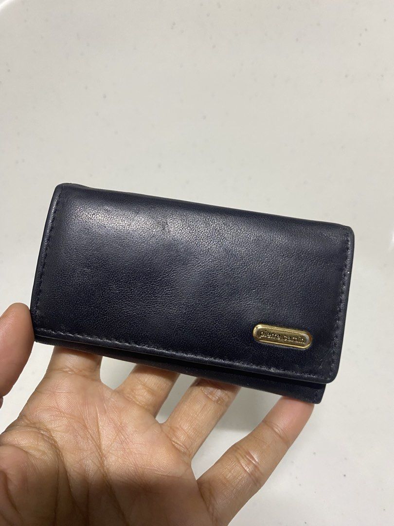 Pierre Cardin Black Leather Key Case Holder (Category: Wallets & Card holders) located in Pasacao. Submitted by wengpullar37205 (Listing ID 1470905454, Image 1). Description: - Brand: Pierre Cardin - Material: Genuine black leather with gold-tone hardware - Capacity: 6 interior key hooks - Closure: Secure snap button closure - Extra storage: Small interior zippered pocket - Details: Debossed interior logo and front exterior metal brand plaque - C