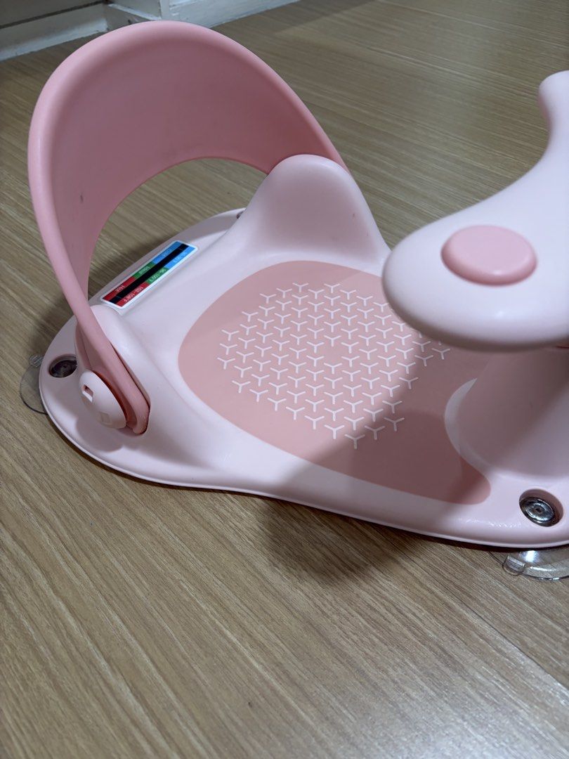 Pink Baby Bath Seat with Suction Cups (Category: Bathtub & Bath Accessories) located in Makati City. Submitted by citysunset (Listing ID 1470754496, Image 2). Description: - Color: Cute pink - Safety: Strong suction cups at the base to prevent slipping - Comfort: Includes a supportive backrest and non-slip textured seat - Feature: Built-in temperature strip indicator on the back plate - Convenience: Easy to wipe down and store after use.