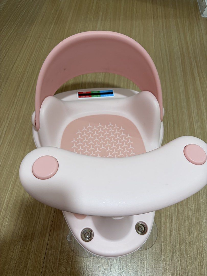Pink Baby Bath Seat with Suction Cups (Category: Bathtub & Bath Accessories) located in Makati City. Submitted by citysunset (Listing ID 1470754496, Image 3). Description: - Color: Cute pink - Safety: Strong suction cups at the base to prevent slipping - Comfort: Includes a supportive backrest and non-slip textured seat - Feature: Built-in temperature strip indicator on the back plate - Convenience: Easy to wipe down and store after use.