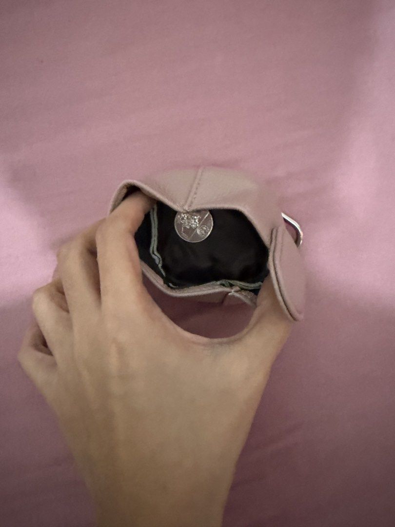 Pink leather mini coin pouch with keyring (Category: Purses & Pouches) located in Davao. Submitted by fabdeclutter (Listing ID 1470927355, Image 2). Description: - Color: Dusty pink with textured leather - Hardware: Silver metal ring attachment for easy clipping - Closure: Flap with vertical tab detail - Interior: Black fabric lining, ideal for coins and tiny accessories - Versatile: Compact size, perfect for bags or keys.