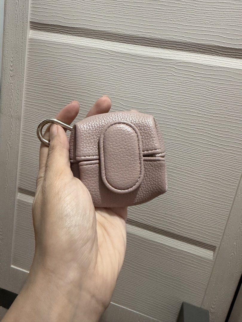 Pink leather mini coin pouch with keyring (Category: Purses & Pouches) located in Davao. Submitted by fabdeclutter (Listing ID 1470927355, Image 1). Description: - Color: Dusty pink with textured leather - Hardware: Silver metal ring attachment for easy clipping - Closure: Flap with vertical tab detail - Interior: Black fabric lining, ideal for coins and tiny accessories - Versatile: Compact size, perfect for bags or keys.