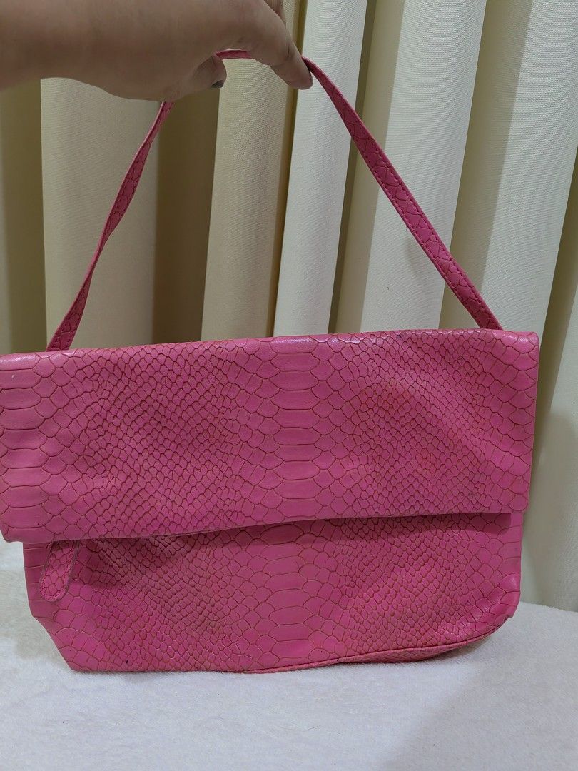 Pink snakeskin shoulder bag (Category: Shoulder Bags) located in Makati City. Submitted by prelovedtreatedwithlove (Listing ID 1470867193, Image 2). Description: - Color: Bright pink - Material: Faux snakeskin texture - Design: Foldover flap with a clean, structured silhouette - Strap: Single strap, comfortable for shoulder or hand carry - Style: Fun statement piece to elevate any outfit No issue.
