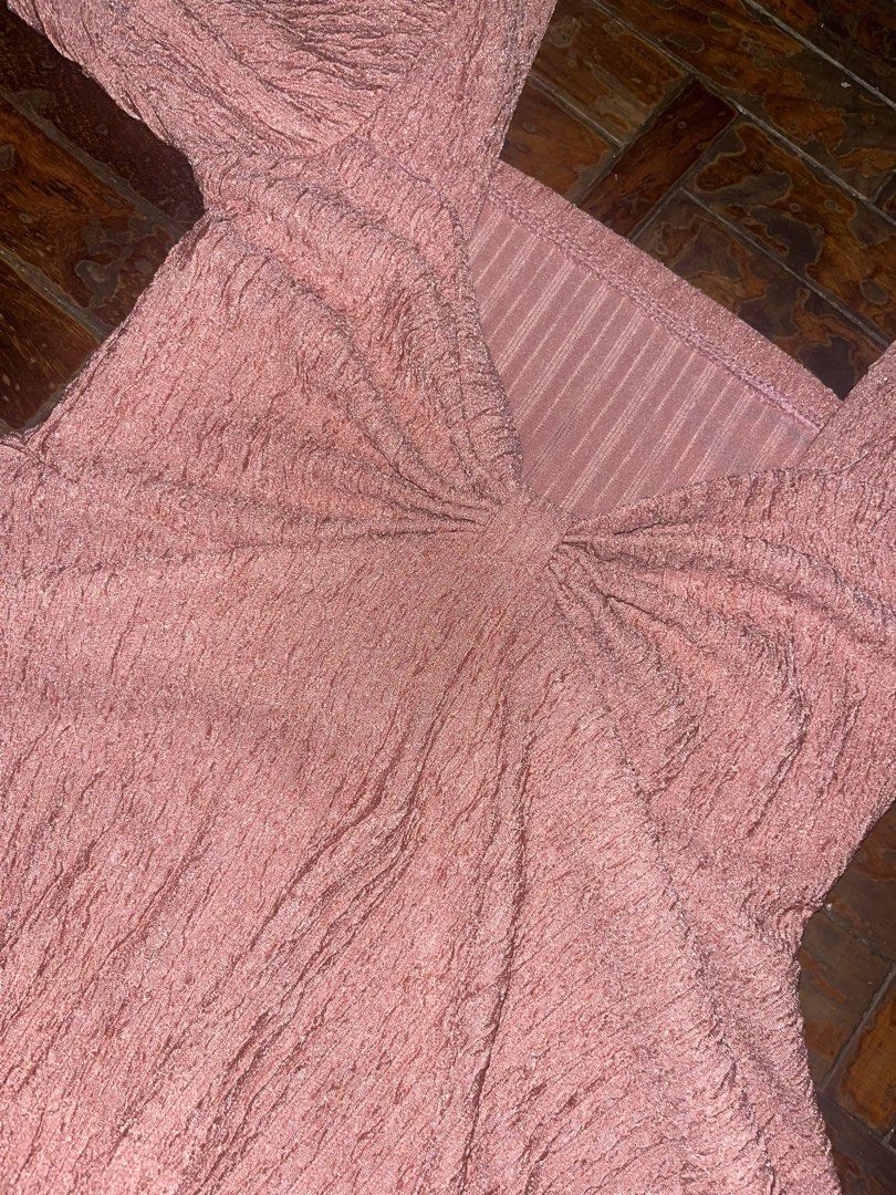 Pink textured square neck peplum top (Category: Sleeveless) located in Mandaluyong City. Submitted by copthatgirl (Listing ID 1470888079, Image 2). Description: - Color: Dusty Pink - Style: Square neckline with short puff sleeves - Detail: Gathered knot at the center chest and flared peplum hem - Comfort: Soft fabric with stretchy ribbed paneling at the back neckline - Versatility: Easy to pair with both jeans and skirts.