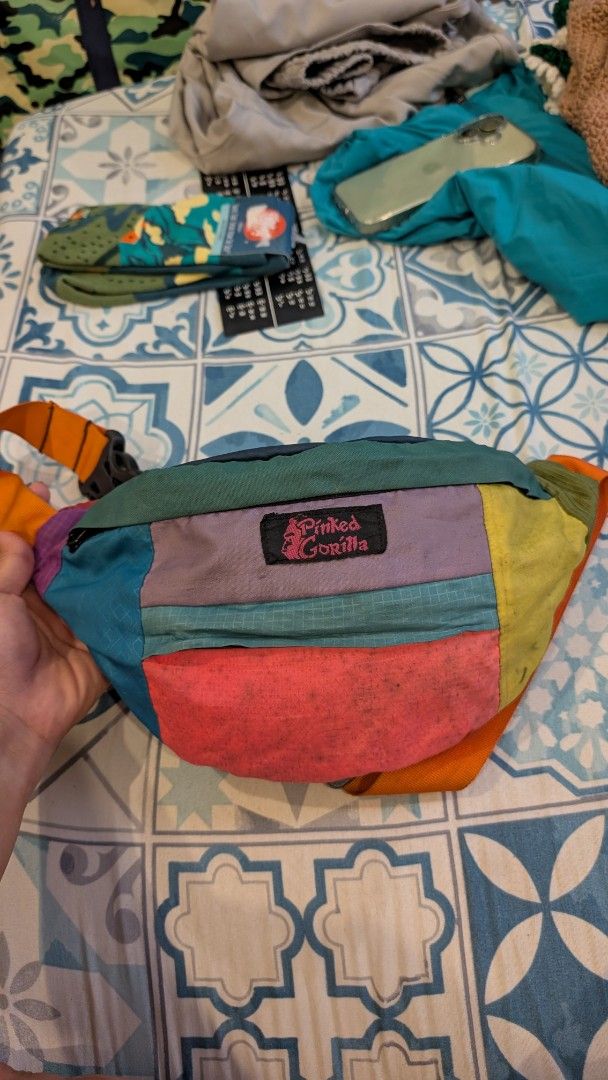 Pinked Gorilla Patchwork Fanny Pack Waist Bag (Category: Belt bags, Clutches and Pouches) located in Manila. Submitted by alypacis06 (Listing ID 1470764616, Image 3). Description: - Brand: Pinked Gorilla - Design: Multi-color patchwork in yellow, pink, blue, purple, and green - Strap: Adjustable orange strap with a sturdy black buckle - Pockets: Secure top zip closure, front pocket, and interior zippered compartments - Versatility: Can be worn cr