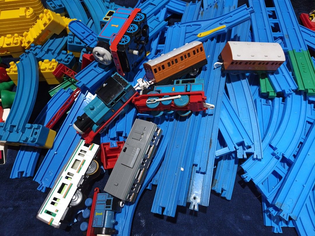 Plarail Thomas and Friends Track Set with Trains (Category: Action & Battle Toys) located in Manila. Submitted by kirstentoyshub (Listing ID 1470838172, Image 2). Description: - 90PCS + TRACKS AND PARTS - WITH TWO WORKING MOTORIZED TRAINS Massive Thomas & Friends railway bundle with motorized trains, passenger coaches, and a grey commuter train - Includes a large assortment of straight and curved blue plastic tracks for custom layouts - Features 