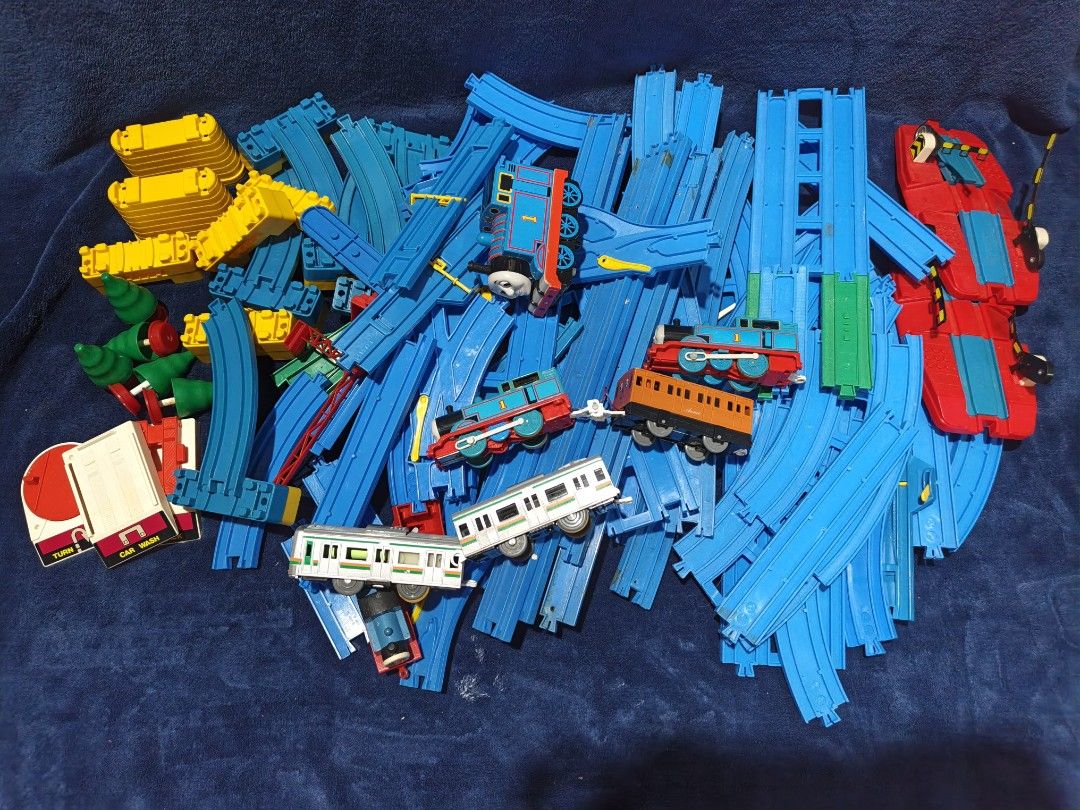 Plarail Thomas and Friends Track Set with Trains (Category: Action & Battle Toys) located in Manila. Submitted by kirstentoyshub (Listing ID 1470838172, Image 1). Description: - 90PCS + TRACKS AND PARTS - WITH TWO WORKING MOTORIZED TRAINS Massive Thomas & Friends railway bundle with motorized trains, passenger coaches, and a grey commuter train - Includes a large assortment of straight and curved blue plastic tracks for custom layouts - Features 