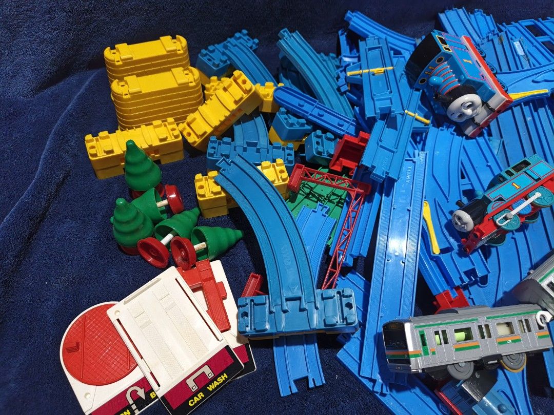 Plarail Thomas and Friends Track Set with Trains (Category: Action & Battle Toys) located in Manila. Submitted by kirstentoyshub (Listing ID 1470838172, Image 3). Description: - 90PCS + TRACKS AND PARTS - WITH TWO WORKING MOTORIZED TRAINS Massive Thomas & Friends railway bundle with motorized trains, passenger coaches, and a grey commuter train - Includes a large assortment of straight and curved blue plastic tracks for custom layouts - Features 