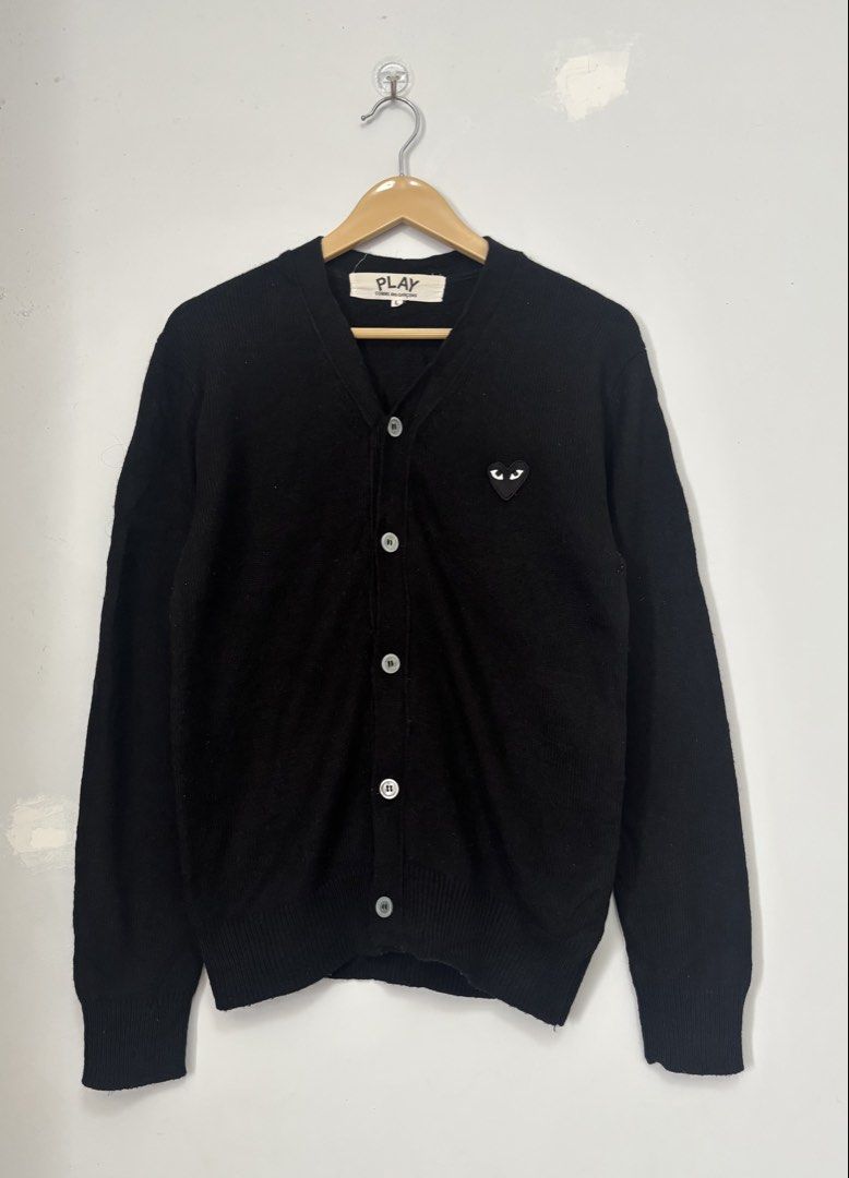 Play Comme des Garcons Black Cardigan Size L (Category: Coats, Jackets and Outerwear) located in Bacolod City. Submitted by gilbertgon94115 (Listing ID 1470809537, Image 1). Description: - Brand: Play Comme des Garçons - Item: Classic V-neck button-down cardigan - Color: Black - Size: Large (L) - Dimes: Width 19 ; Length 25 - Material: 100% Cotton, Made in Japan - Details: Iconic embroidered black heart patch with white eyes, ribbed cuffs and hem