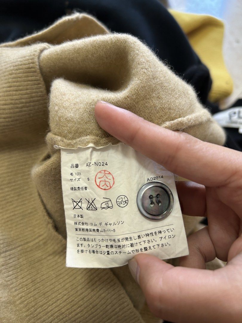 Play Comme des Garcons Wool Cardigan Size S (Category: Coats, Jackets and Outerwear) located in Bacolod City. Submitted by gilbertgon94115 (Listing ID 1470825495, Image 3). Description: - Brand: Play Comme des Garcons - Color: Camel Brown - Size: Small (S) - Dimes: Width 15 ; L 23 - Material: 100% Wool, Made in Japan - Design: Button-down front with iconic black heart patch - Condition: Clean with interior tags intact.