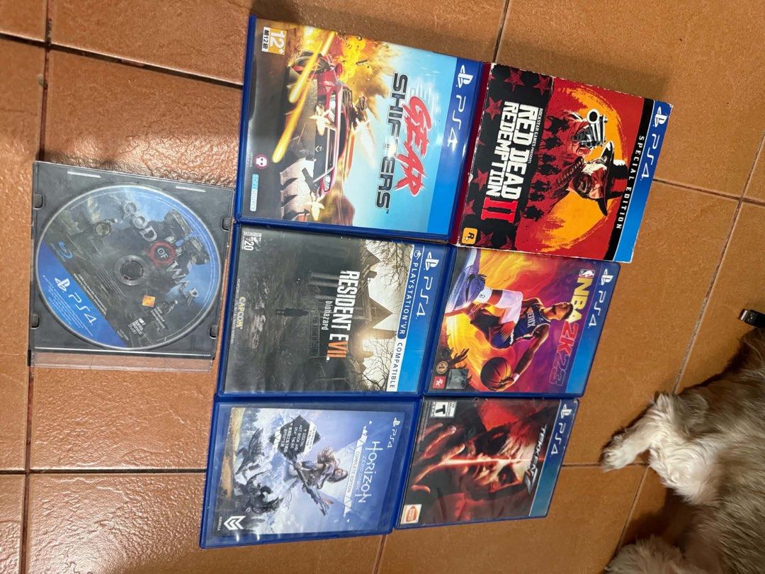 PlayStation 4 console with two controllers and games plus psp jb (Category: PlayStation) located in Manila. Submitted by fitibles (Listing ID 1470837262, Image 2). Description: - 2 matching blue controllers - PSP handheld included - Plug adapter included - 7 popular games: Red Dead Redemption II Special Edition, NBA 2K23, Horizon Zero Dawn, Resident Evil, Gear Shifters, Tekken, and God of War - Perfect all-in-one gaming bundle.