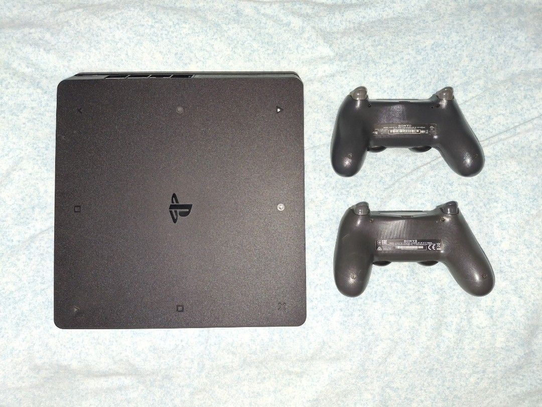 PlayStation 4 Slim 1TB Console with Two Controllers and Games (Category: PlayStation) located in General Trias. Submitted by maxinne_gb (Listing ID 1470776712, Image 2). Description: - Console: PlayStation 4 Slim 1TB (Fully tested and 100% working) - Controllers: 2 units included (1 Original DualShock 4 + 1 OEM controller) - Games: Far Cry 5 and Tiny Tina's Wonderlands - Accessories included: Charging cable, extra thumb grips, decorative stickers