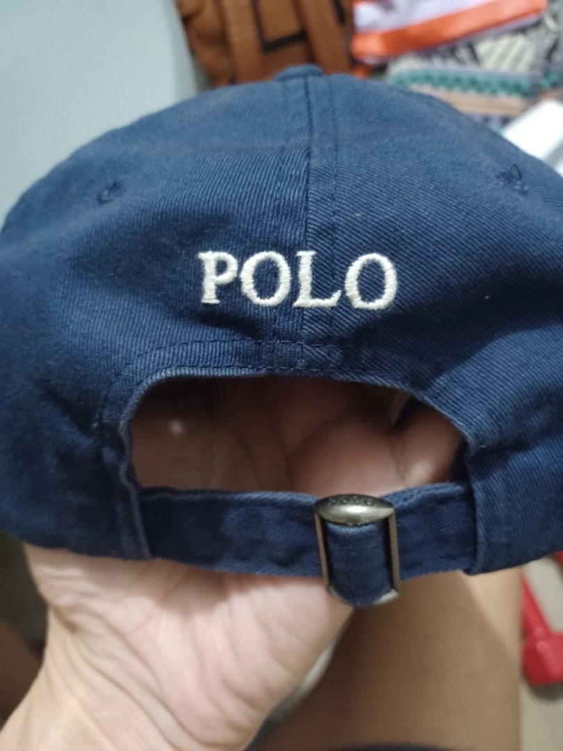 Polo Ralph Lauren Navy Baseball Cap (Category: Caps & Hats) located in Mandaluyong City. Submitted by usamenfashionhaul (Listing ID 1470912608, Image 2). Description: - Brand: Polo Ralph Lauren - Color: Dark blue - Material: 100% Cotton (verified by interior tags) - Design: Embroidered player logo on the front - Back Detail: 'POLO' embroidered text with adjustable metal buckle strap - Condition: Excellent, ready to wear - Perfect for casual every