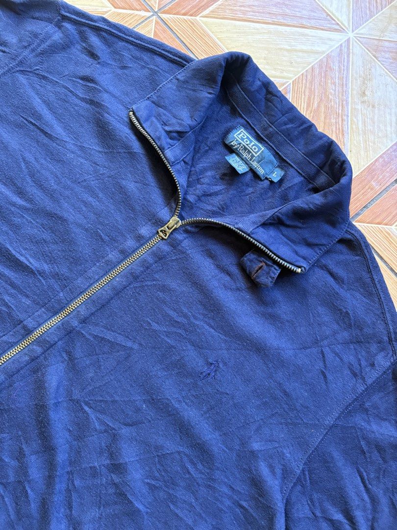 Polo Ralph Lauren Navy Zip Jacket Size L (Category: Coats, Jackets and Outerwear) located in Baybay. Submitted by jhondhelbe76855 (Listing ID 1470801874, Image 3). Description: - Brand: Polo Ralph Lauren - Color: Navy Blue - Size: Large - Style: Full-zip jacket with collar neck - Features: Front zipper pockets, ribbed cuffs and hem - Condition/Vibe: Classic staple piece, perfect for layering over tees or hoodies in cooler weather.