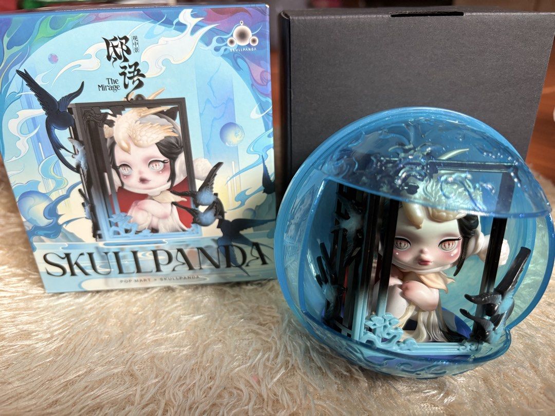 POP MART Skullpanda The Mirage Figurine (Category: Designer & Blind Box Toys) located in Taguig. Submitted by quin.zeey (Listing ID 1470764550, Image 1). Description: - Item: POP MART Skullpanda The Mirage blind box figure - Condition: Opened box underneath to check character only; figure remains untouched inside its packaging - Packaging: Comes in a blue translucent dome case with tiny bird details - Inclusions: Original outer box and black inne