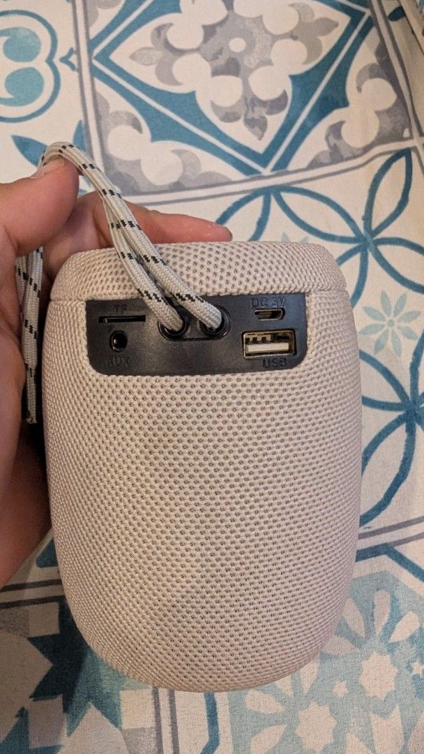 Portable Wireless Speaker and Earbuds Set (Category: Soundbars, Speakers & Amplifiers) located in Manila. Submitted by alypacis06 (Listing ID 1470767029, Image 2). Description: - Sleek beige cylindrical Bluetooth speaker with fabric mesh and carrying strap - Easy-access top controls for volume, power, and pairing - Versatile connectivity: TF card slot, AUX, micro-USB, and standard USB port - Includes matching white wireless charging case with ope