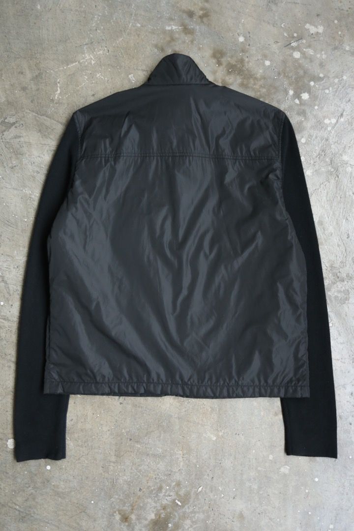 Prada - Wool-Trimmed Blouson (Category: Coats, Jackets and Outerwear) located in Manila. Submitted by graymatter_ (Listing ID 1470827854, Image 2). Description: Prada - Wool-Trimmed Blouson circa 2001-2005 Tagged Size: L Condition: 9/10 Flaws: Minor Tear on 1 Pit Material: 100% Nylon, 70% Lana Wool, 30% Cashmere Zipper: Riri Made in: Italy Dimensions Length: 26.5 Width: 22.5 Shoulder: 18 Sleeve: 29.