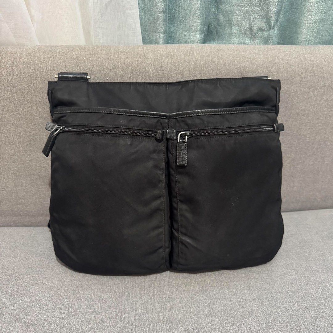 Prada Black Nylon Messenger Crossbody Bag (Category: Luxury Bags & Wallets) located in Madrid. Submitted by jhunaceee (Listing ID 1470830053, Image 3). Description: - Authentic black Prada nylon crossbody bag - Iconic enamel triangle logo on the front - Dual exterior zip pockets on the back for easy access - Adjustable thick webbing shoulder strap with sturdy hardware - Premium leather trim details along the sides and zippers - Practical daily si