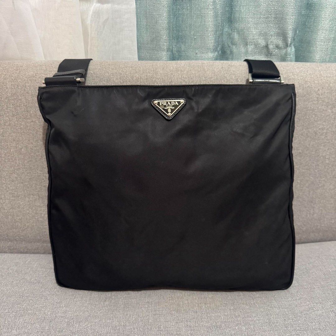 Prada Black Nylon Messenger Crossbody Bag (Category: Luxury Bags & Wallets) located in Madrid. Submitted by jhunaceee (Listing ID 1470830053, Image 2). Description: - Authentic black Prada nylon crossbody bag - Iconic enamel triangle logo on the front - Dual exterior zip pockets on the back for easy access - Adjustable thick webbing shoulder strap with sturdy hardware - Premium leather trim details along the sides and zippers - Practical daily si