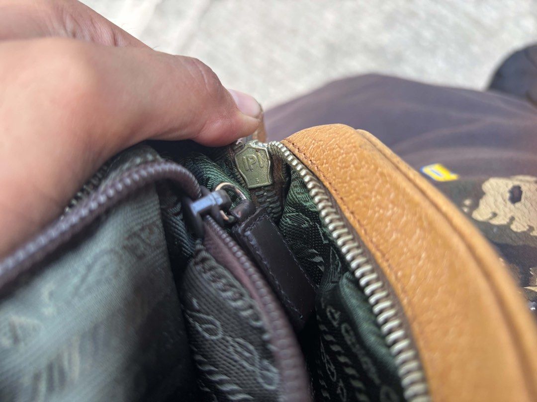 Prada Brown Leather Shoulder Bag with Buckle (Category: Luxury Bags & Wallets) located in General Santos City (Dadiangas). Submitted by rachelleclosets2026._gem (Listing ID 1470835113, Image 3). Description: - Authentic Prada shoulder bag in rich textured brown leather - Stylish silver hardware buckle detail on the front flap - Secure zip closure with durable fabric lining - Adjustable strap with metal clasps for a custom fit - Features 'Made in 