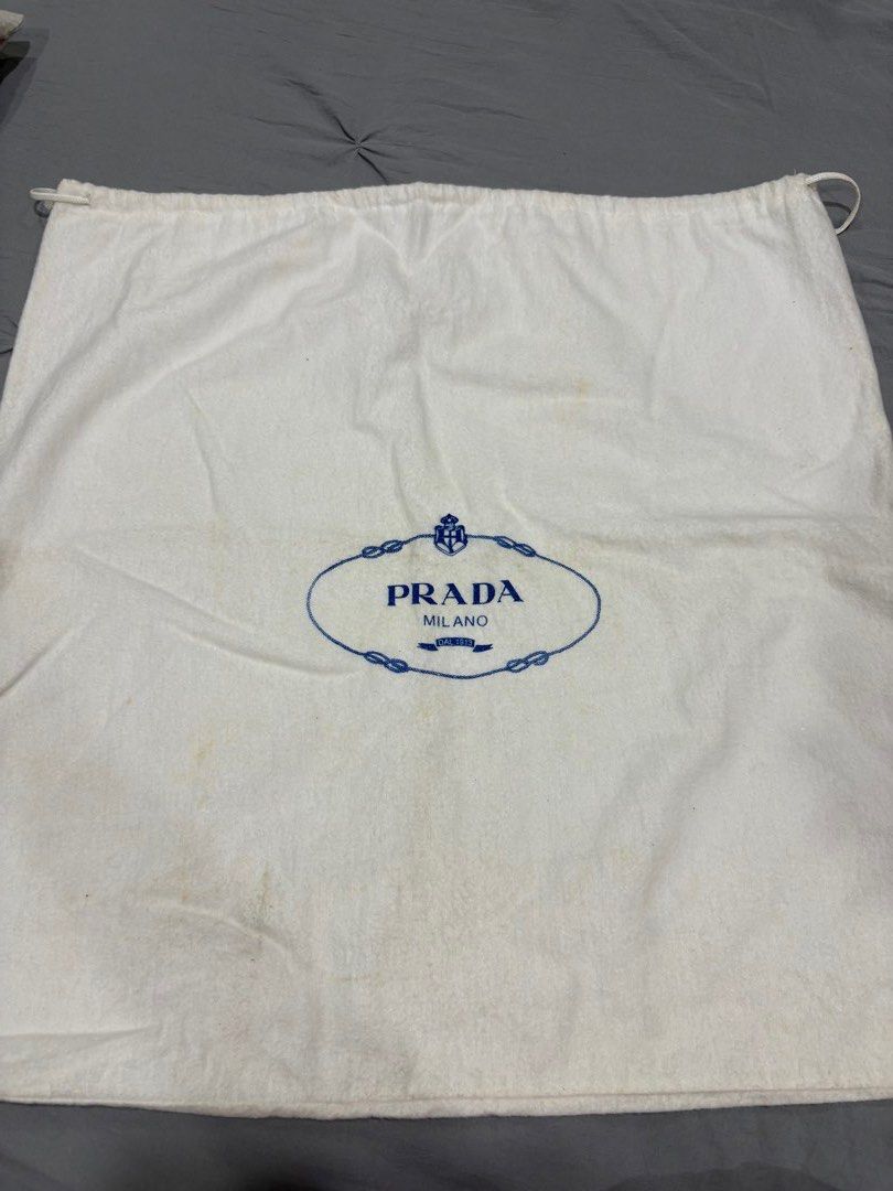 Prada Dust Bag White Blue Logo (Category: Luxury Bags & Wallets) located in Muntinlupa City. Submitted by rmsalberto (Listing ID 1470836545, Image 1). Description: - Item: Authentic Prada dust bag - Color: White with classic blue oval logo - Closure: Secure top drawstring - Condition: Shows minor yellowish discoloration spots from storage - Ideal for: Storing and protecting Prada bags or luxury accessories.