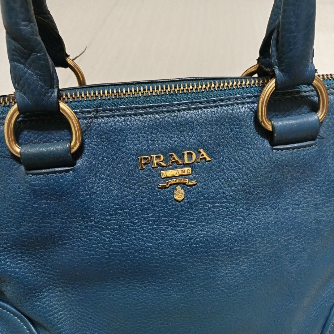 PRADA Leather Shoulder Bag Blue (Category: Luxury Bags & Wallets) located in Nasugbu. Submitted by staffpicks1515 (Listing ID 1470827813, Image 3). Description: - Authentic Prada leather shoulder bag in a stunning blue shade - Elegant gold-tone hardware with secure zip closure - Features double top handles (please note: original sling strap is missing) - Blue fabric-lined interior complete with convenient pockets - Crafted in Italy - Condition: S