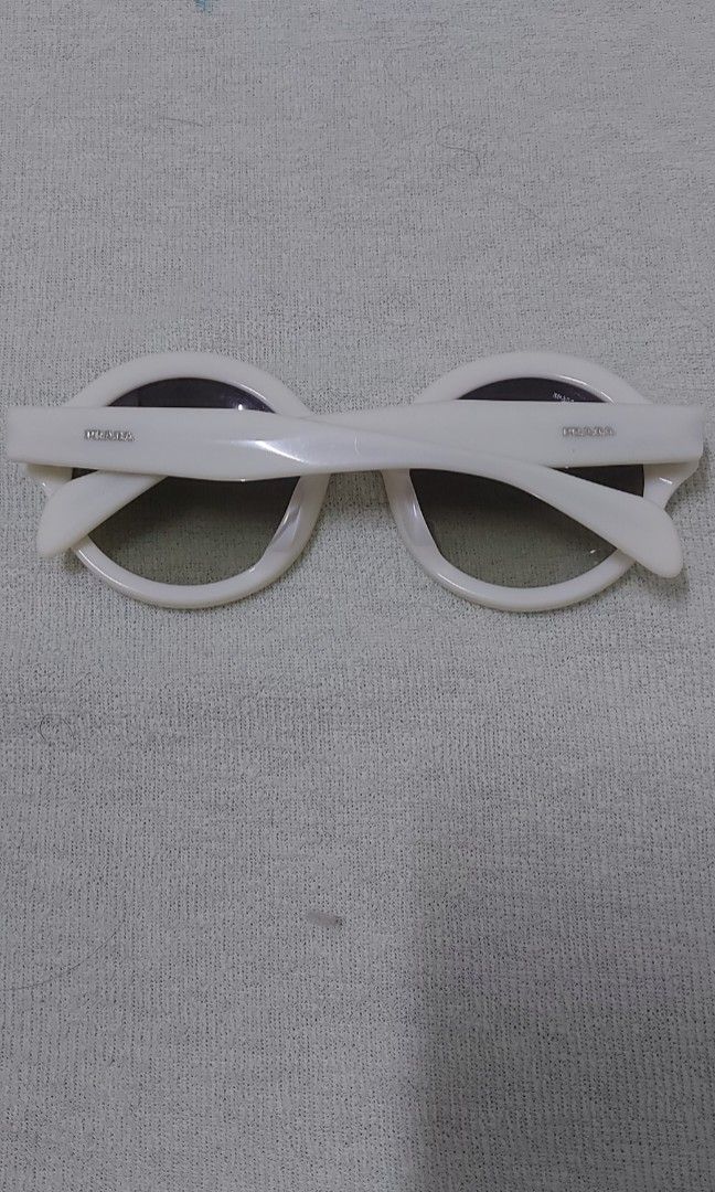 Prada oval eyewear (Category: Sunglasses & Eyewear) located in Quezon City. Submitted by threetwotwo2ndaccount (Listing ID 1470804043, Image 2). Description: Prada oval eyewear with serial sign of usage may konting scratches sa lens, pwedeng papalitan medyo natabingi ung frame as is bawal sa maselan bawal sa barat.