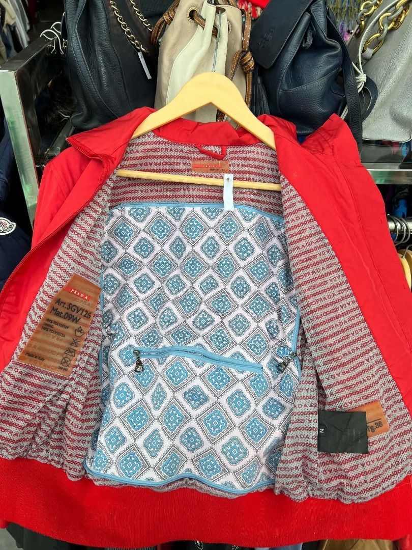 Prada Red Nylon Bomber Jacket Art.SGV126 (Category: Coats, Jackets and Outerwear) located in Urdaneta. Submitted by jayceegarage (Listing ID 1470882000, Image 3). Description: - Brand: Prada - Item: Nylon Bomber Jacket - Color: Red - Size: Medium - Material: 100% Polyester - Made in Italy - Design: Stand collar with ring zip, ribbed red cuffs and hem, branded red fabric tag on right sleeve - Interior: Printed logo mesh lining with patterned accen