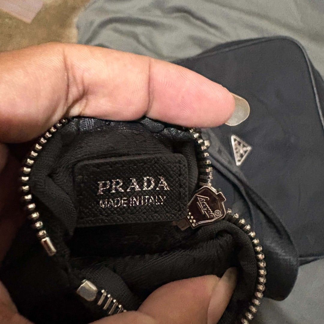 Prada sling bag (Category: Luxury Bags & Wallets) located in Alburquerque. Submitted by abj_thriftshop (Listing ID 1470762515, Image 2). Description: lampo coded sign of used sa rubber lining.