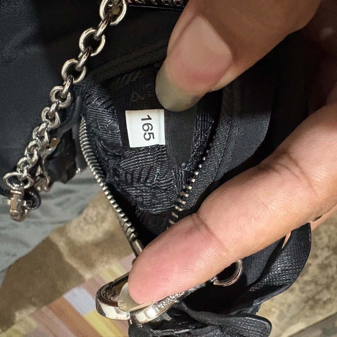 Prada sling bag (Category: Luxury Bags & Wallets) located in Alburquerque. Submitted by abj_thriftshop (Listing ID 1470762515, Image 3). Description: lampo coded sign of used sa rubber lining.