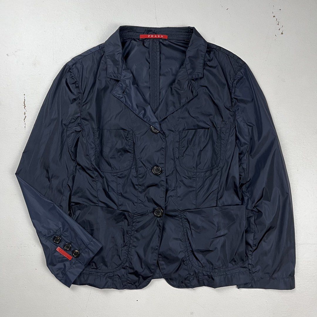 Prada Sport early 2000s nylon chore Jacket (Category: Luxury Apparel) located in Quezon City. Submitted by forgarments (Listing ID 1470831267, Image 1). Description: Prada Sport early 2000s nylon chore Jacket Excellent Condition - Sticky Care label Size: 40 Shoulder: 15.5 Inches Chest width: 17 Inches Waist: 15.5 Inches Sleeve: 19.5 Inches Length: 21 Inches - Convertible Collar & 4 Pocket set up - Sleeve cuffs & Red tab on right sleeve - Buttoned