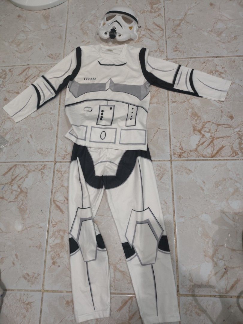 Preloved Star Wars Stormtrooper Costume with Mask (Category: Babies & Kids Fashion) located in Paranaque City. Submitted by enithing_preloved (Listing ID 1470862701, Image 1). Description: - Star Wars Stormtrooper fancy dress outfit - Includes long-sleeve top, matching trousers, and plastic helmet mask - White fabric featuring printed black armor details on front and back - Comfortable elasticated waistband on pants - Ideal for Halloween, themed 