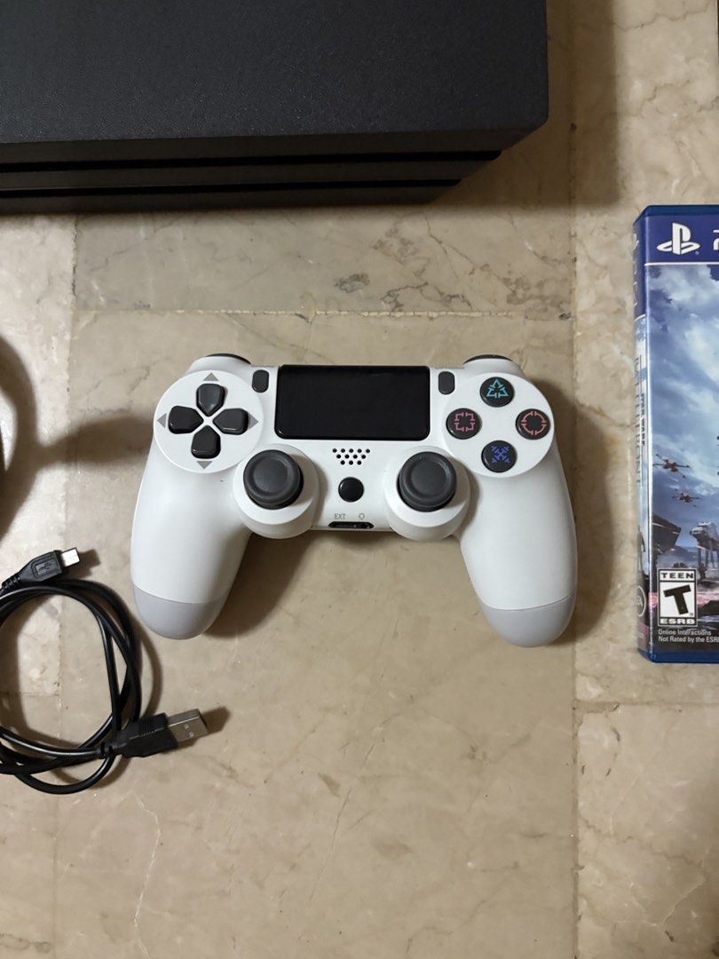 PS4 PRO with games (Category: PlayStation) located in Dasmarinas. Submitted by manga_ (Listing ID 1470915172, Image 3). Description: FOR SALE: PS4 Pro Bundle + 3 Games 🎮 Selling my PS4 Pro! Inclusions: • PS4 Pro console • 1 fake/replacement controller • HDMI cable • Power cable • 3 games: • Star Wars Battlefront • NBA Live 14 • NBA 2K15 • PS4 vertical stand with game disc rack Condition: Used Box: Not included Note: Original controller is broken