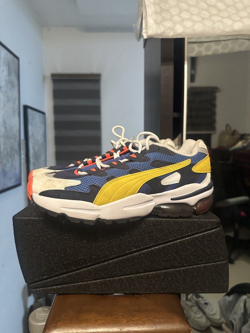 Puma Cell Venom Sneakers Blue Yellow (Category: Sneakers) located in Quezon City. Submitted by prelovedbagsbygiv (Listing ID 1470837368, Image 1). Description: - Model: Retro Puma Cell Venom chunky sneakers - Colorway: Blue mesh upper, black suede overlays, bright yellow Formstrip, and orange accents - Sole: Chunky white midsole with visible heel cushioning window - Details: Classic white laces included - Condition: Normal signs of wear on the wh