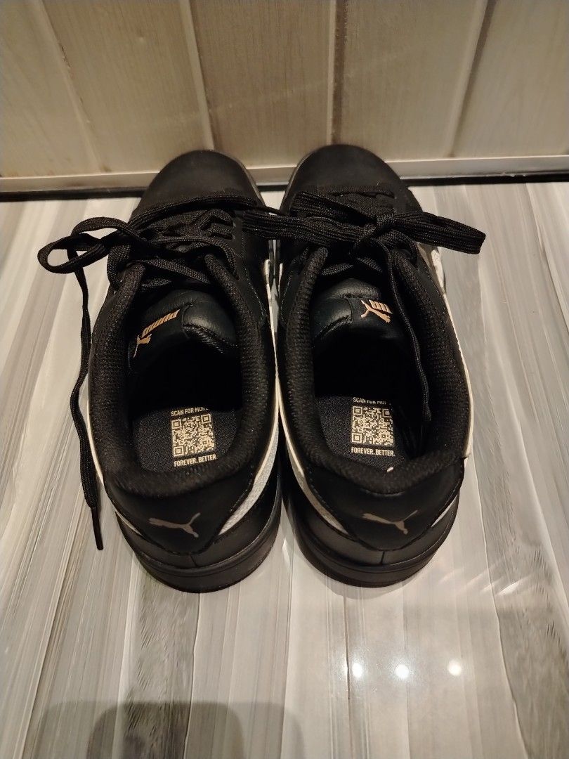 Puma Grounded SL II (black, white, gold) (Category: Sneakers) located in Quezon City. Submitted by stacey_bluey (Listing ID 1470810098, Image 3). Description: - Brand: Puma - Color: Black leather with white side stripes - Details: Gold Puma branding on side, tongue, and heel - Original Puma sneakers - Closure: Lace-up with black laces - Condition: Soles show minimal wear with fully intact tread, clean interior lining - Features: QR code printed o